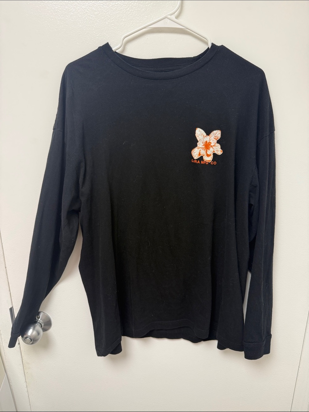 Lira MFG Co. Black Long-Sleeve Tee with Orange Lilly Emblem
